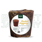 Bucket of jaggery with Organic Mandya label on a white background