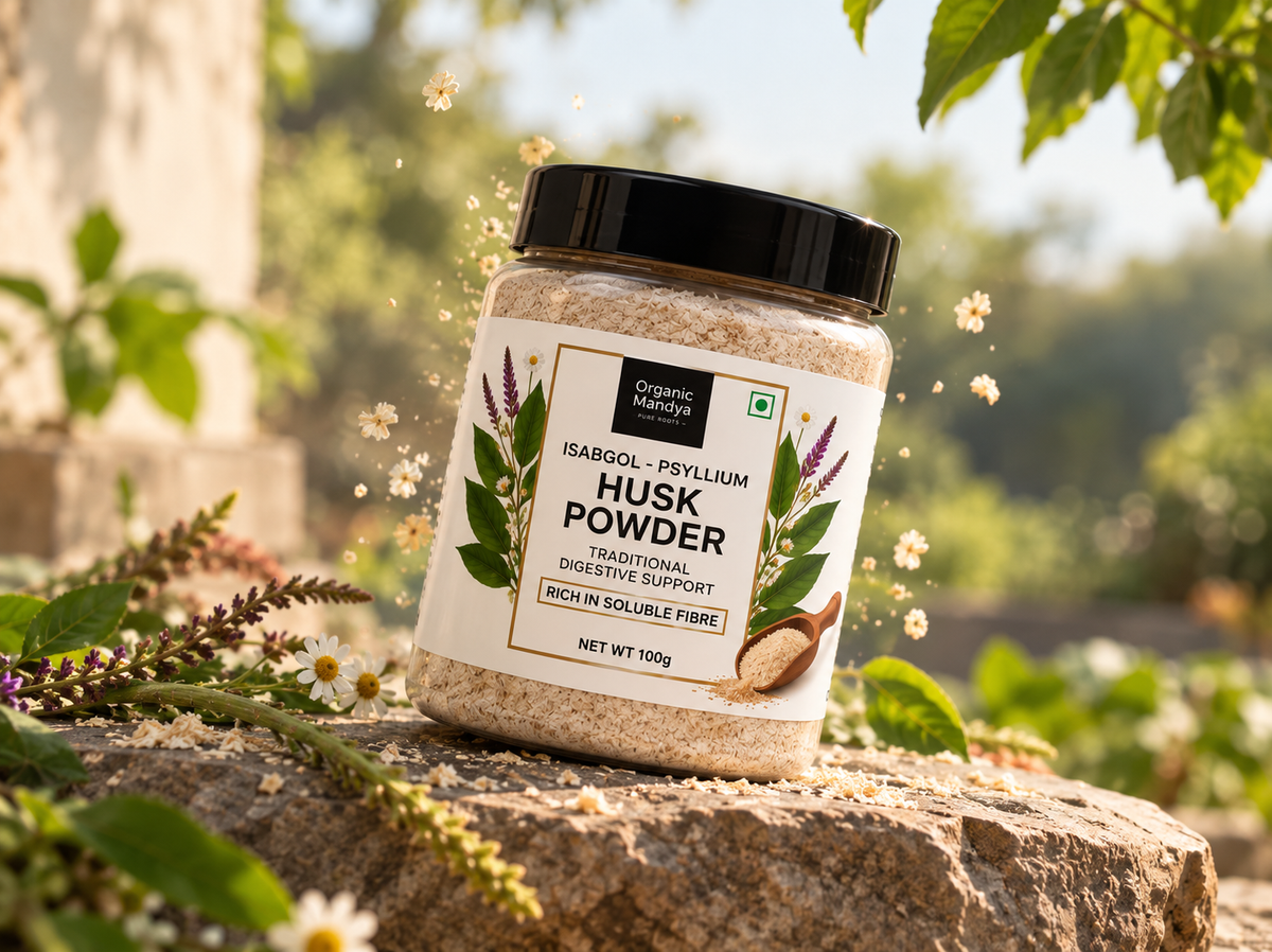 Organic Mandya Isabgol Psyllium Husk Powder jar on a stone ledge, surrounded by wildflowers and drifting husk, with a sunlit garden behind